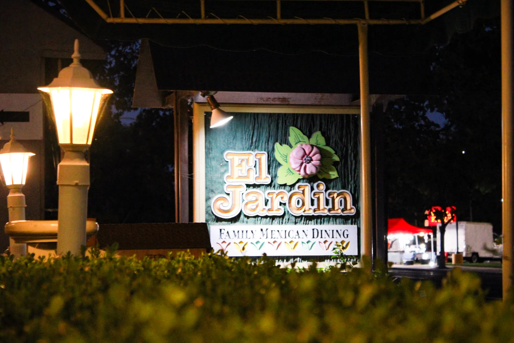 El Jardín's lit sign at night on 409 E Olive Ave